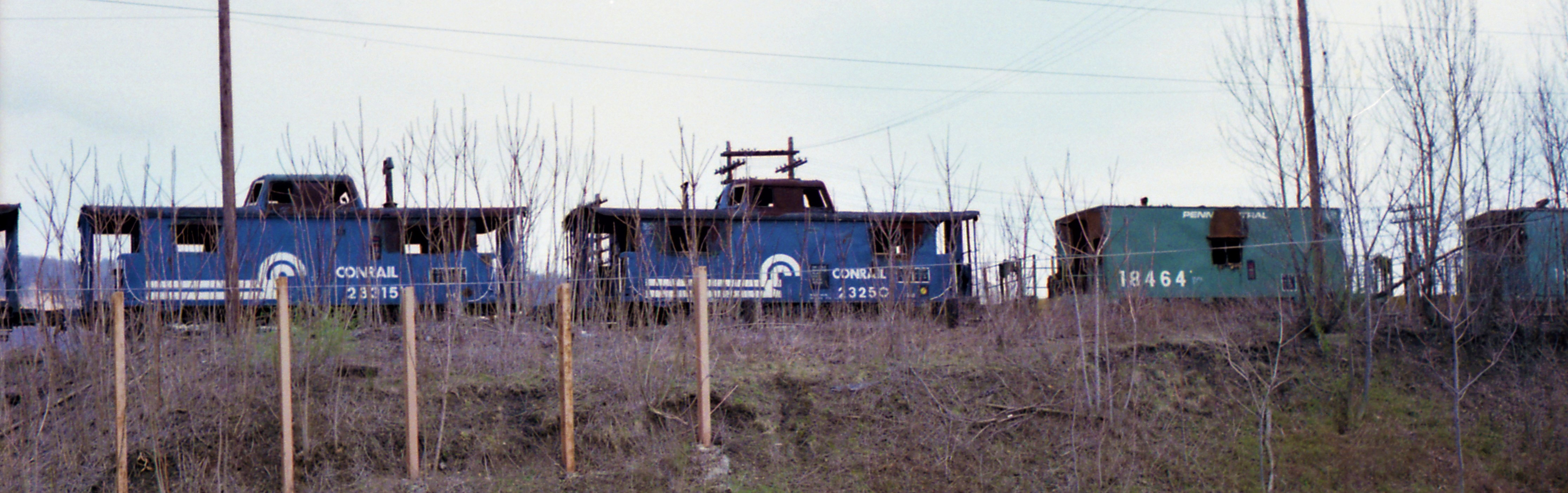 A scene repeated across the country in the 1980's, cabooses are lined up to be scrapped.